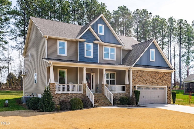 50 Lockamy Ln, Youngsville, NC 27596 - craftsman-style house featuring a porch, concrete driveway, a garage, stone siding, and board and batten siding