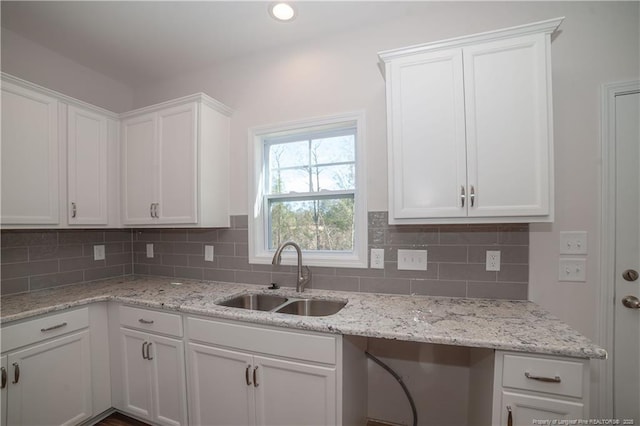 333 Edwinstowe Ave, Fayetteville, NC 28311 - kitchen with a sink, white cabinets, decorative backsplash, and light stone countertops