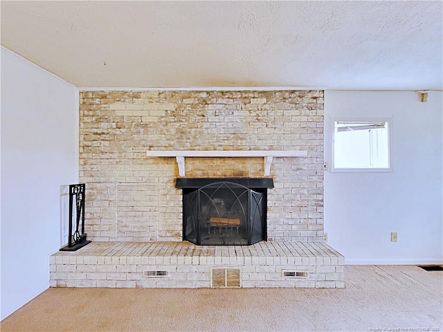 details with carpet flooring, a brick fireplace, a textured ceiling, and visible vents