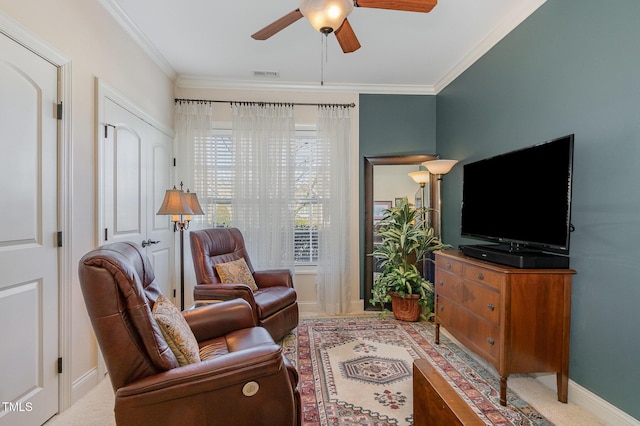 living room featuring a ceiling fan, crown molding, and baseboards