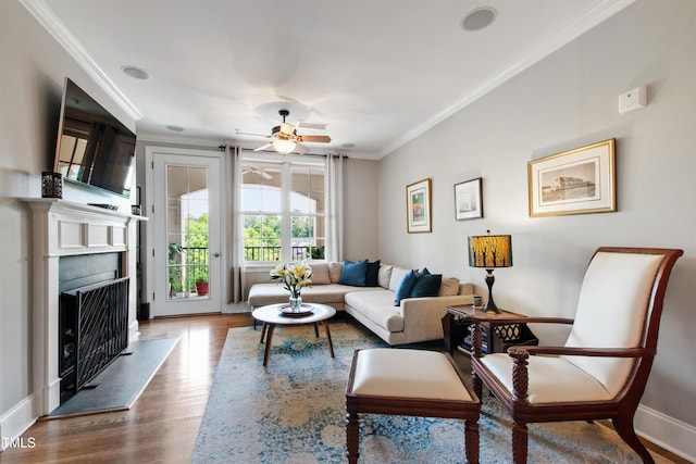 340 Allister Dr Unit 201, Raleigh, NC 27609 - living area featuring ornamental molding, baseboards, dark wood-type flooring, a fireplace with raised hearth, and a ceiling fan