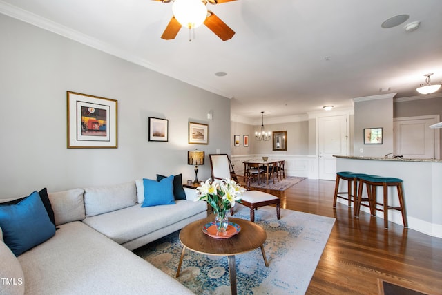 340 Allister Dr Unit 201, Raleigh, NC 27609 - living area featuring ornamental molding, ceiling fan with notable chandelier, and dark wood-style floors