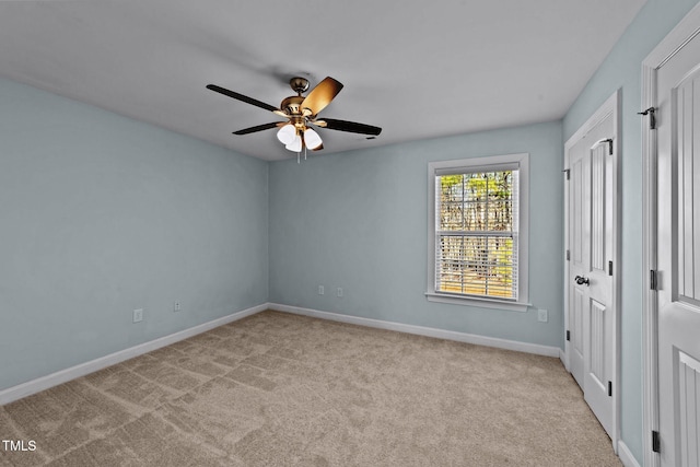 unfurnished bedroom featuring a ceiling fan, baseboards, and carpet