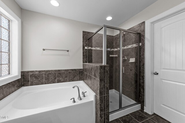 bathroom featuring a bath, a shower stall, tile patterned floors, and plenty of natural light
