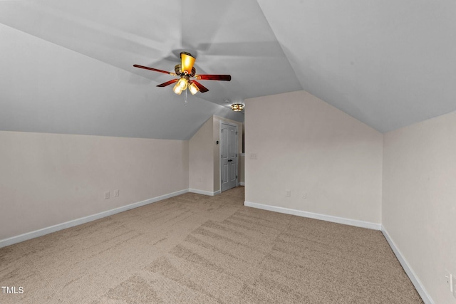 additional living space with vaulted ceiling, carpet, baseboards, and ceiling fan