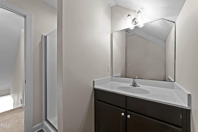 full bathroom with vaulted ceiling, vanity, and a stall shower