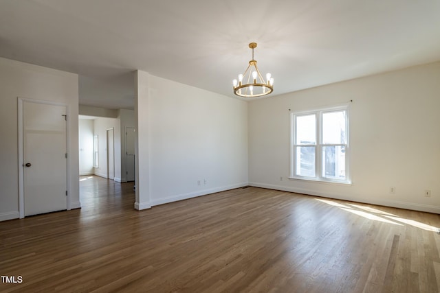 118 Riverwood Dr, Fuquay Varina, NC 27526 - empty room with a notable chandelier, baseboards, and wood finished floors