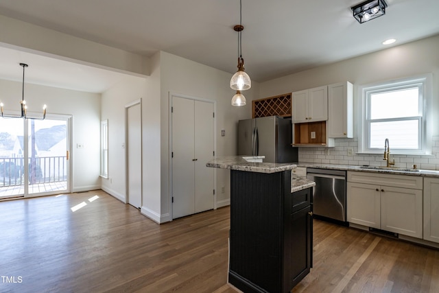118 Riverwood Dr, Fuquay Varina, NC 27526 - kitchen featuring backsplash, a center island, dark wood finished floors, appliances with stainless steel finishes, and a sink