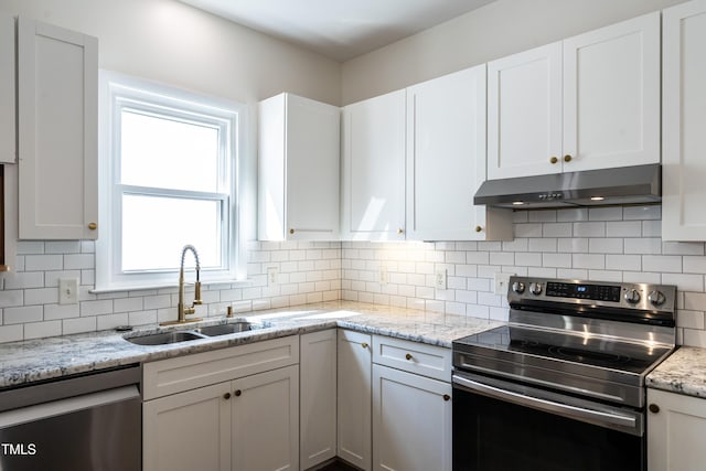 118 Riverwood Dr, Fuquay Varina, NC 27526 - kitchen with a sink, decorative backsplash, stainless steel appliances, under cabinet range hood, and white cabinetry
