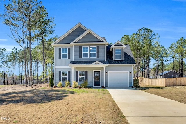 view of front of property with driveway, an attached garage, a front lawn, and fence