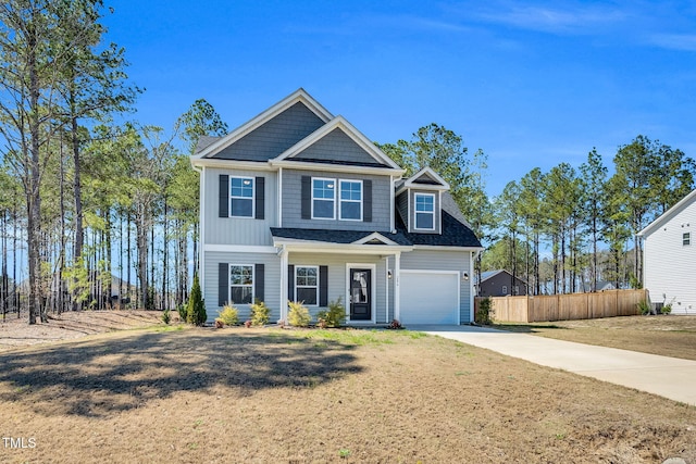 view of front of home featuring concrete driveway, fence, and a garage