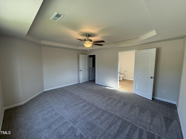 87 Heatherglenn Cir, Princeton, NC 27569 - unfurnished bedroom with a tray ceiling, carpet flooring, baseboards, and visible vents