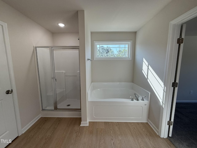 87 Heatherglenn Cir, Princeton, NC 27569 - bathroom with a shower stall, a garden tub, wood finished floors, and baseboards