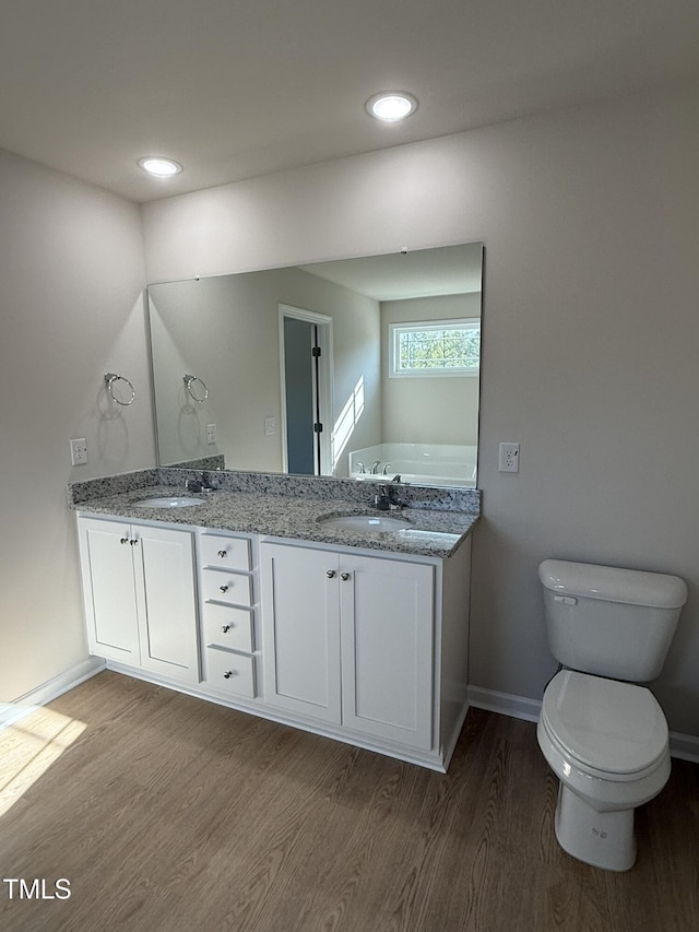 87 Heatherglenn Cir, Princeton, NC 27569 - full bathroom with baseboards, a sink, toilet, double vanity, and wood finished floors