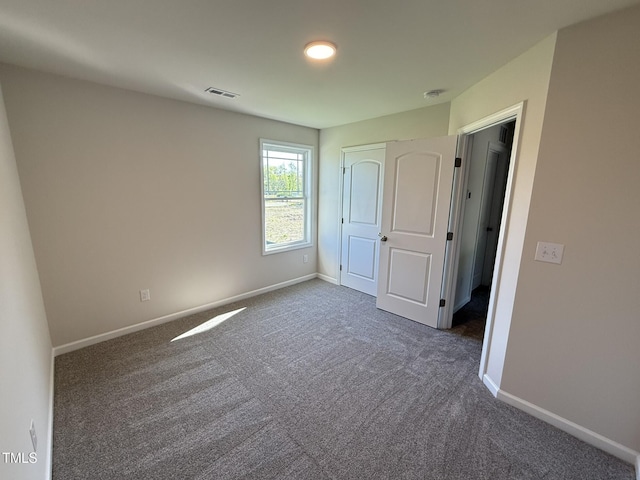 87 Heatherglenn Cir, Princeton, NC 27569 - unfurnished bedroom featuring dark carpet, visible vents, baseboards, and a closet