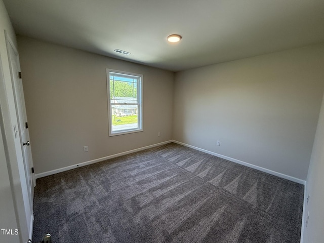 87 Heatherglenn Cir, Princeton, NC 27569 - unfurnished room featuring dark colored carpet, visible vents, and baseboards