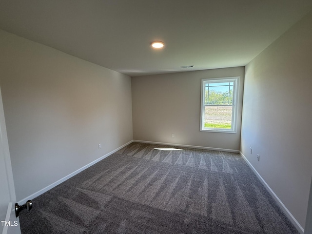 87 Heatherglenn Cir, Princeton, NC 27569 - empty room featuring dark carpet, baseboards, and visible vents