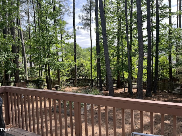 wooden deck with a fenced backyard