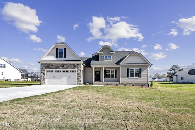 view of front facade with a front yard, concrete driveway, and a garage