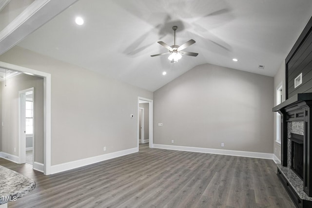 unfurnished living room featuring a fireplace, ceiling fan, dark wood-type flooring, and vaulted ceiling