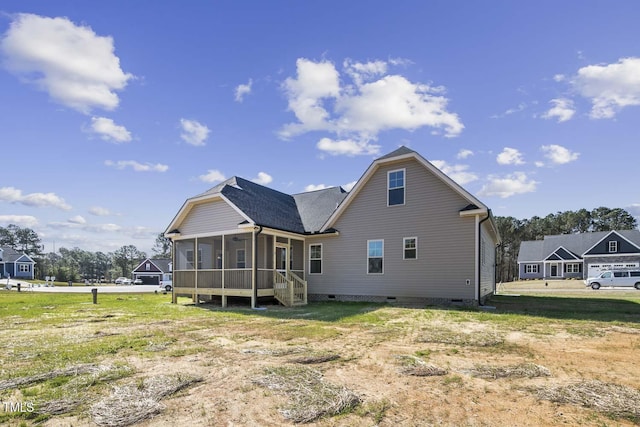rear view of property featuring a sunroom and crawl space