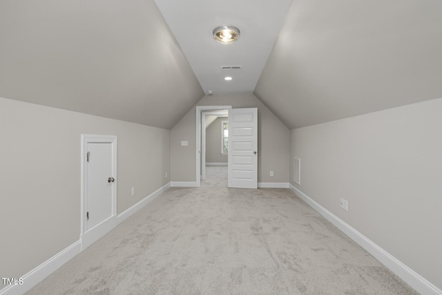 bonus room with baseboards, visible vents, and vaulted ceiling