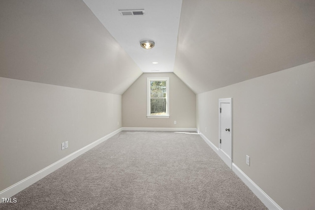 bonus room featuring baseboards, visible vents, carpet flooring, and vaulted ceiling