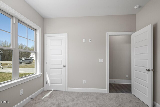 unfurnished bedroom featuring baseboards and carpet floors