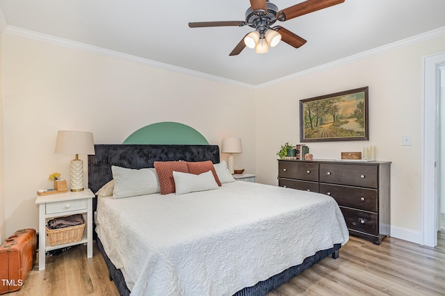 bedroom featuring baseboards, ornamental molding, and light wood-style flooring