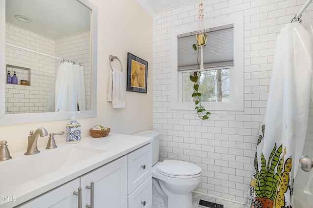 bathroom featuring tile walls, vanity, toilet, a tile shower, and visible vents