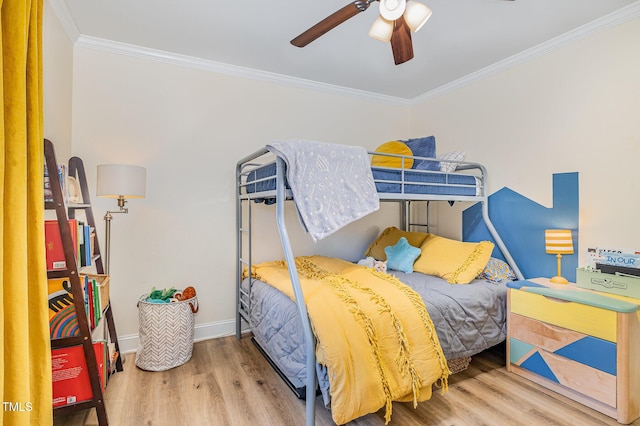 bedroom featuring baseboards, wood finished floors, ceiling fan, and ornamental molding