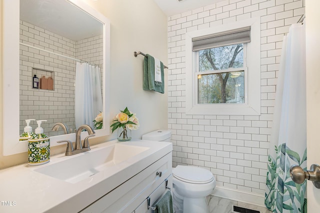 full bathroom with tiled shower, marble finish floor, toilet, vanity, and visible vents