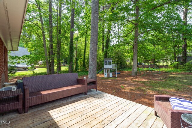 wooden terrace with an outdoor living space and a playground