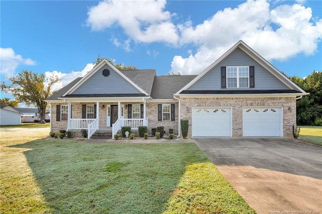 craftsman house featuring driveway, a porch, a front lawn, a garage, and brick siding