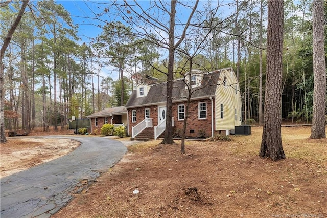 12621 Coble Dr, Laurinburg, NC 28352 - view of front of house with brick siding, aphalt driveway, roof with shingles, cooling unit, and crawl space