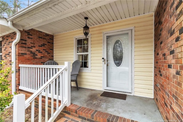 12621 Coble Dr, Laurinburg, NC 28352 - view of exterior entry featuring a porch and brick siding