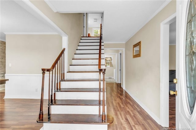 12621 Coble Dr, Laurinburg, NC 28352 - stairs with baseboards, wood finished floors, and ornamental molding