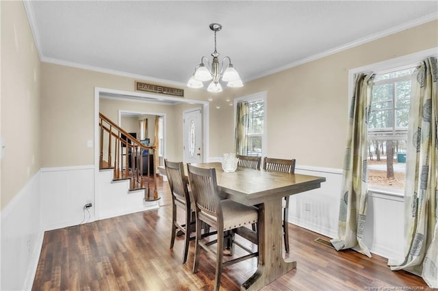 12621 Coble Dr, Laurinburg, NC 28352 - dining space with stairway, a notable chandelier, dark wood finished floors, and crown molding