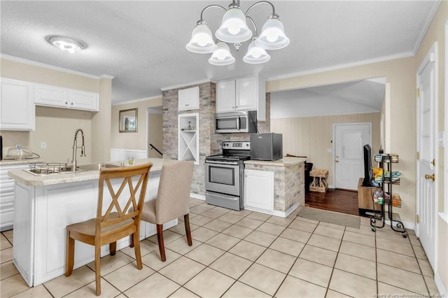12621 Coble Dr, Laurinburg, NC 28352 - kitchen featuring a sink, appliances with stainless steel finishes, light tile patterned floors, and light countertops