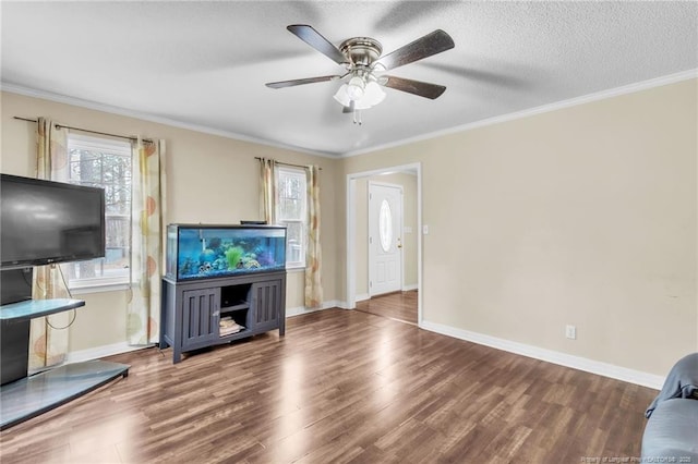 12621 Coble Dr, Laurinburg, NC 28352 - living room featuring a textured ceiling, wood finished floors, crown molding, baseboards, and ceiling fan
