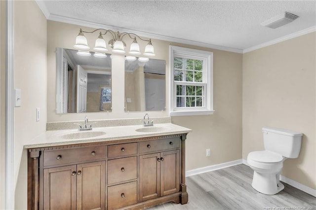 12621 Coble Dr, Laurinburg, NC 28352 - full bath with a sink, visible vents, a textured ceiling, and wood finished floors