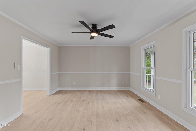 unfurnished room featuring visible vents, crown molding, baseboards, a ceiling fan, and light wood-type flooring
