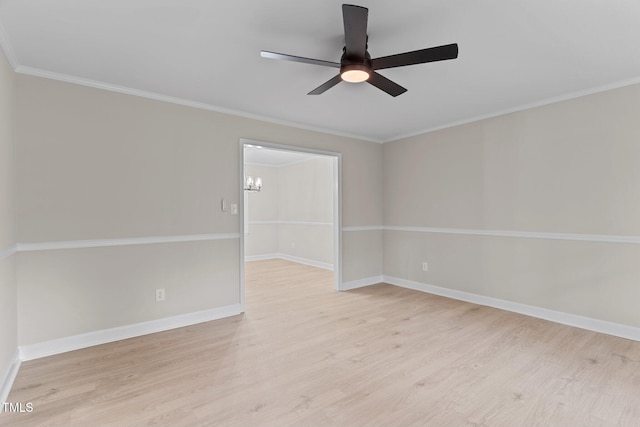 empty room featuring a ceiling fan, crown molding, baseboards, and wood finished floors
