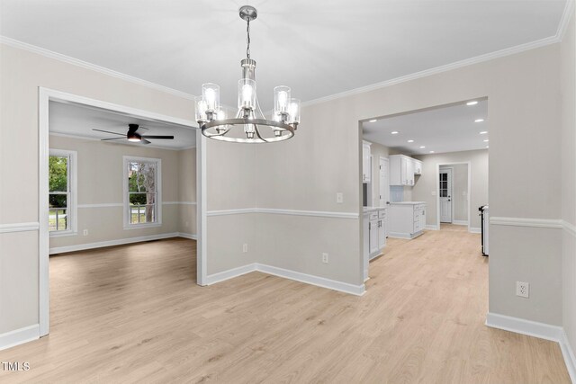 unfurnished dining area featuring baseboards, ornamental molding, recessed lighting, light wood-type flooring, and ceiling fan with notable chandelier