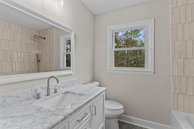 bathroom featuring bathtub / shower combination, toilet, vanity, tile patterned flooring, and baseboards