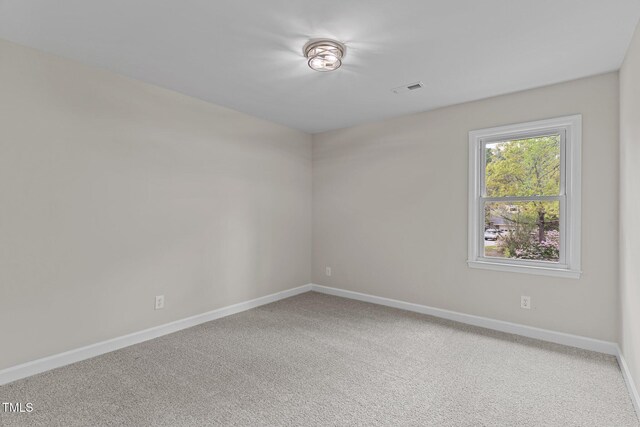 unfurnished room featuring carpet, baseboards, and visible vents