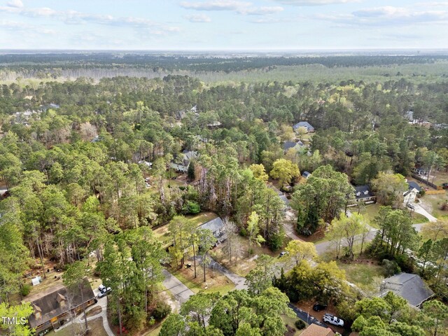 birds eye view of property with a forest view