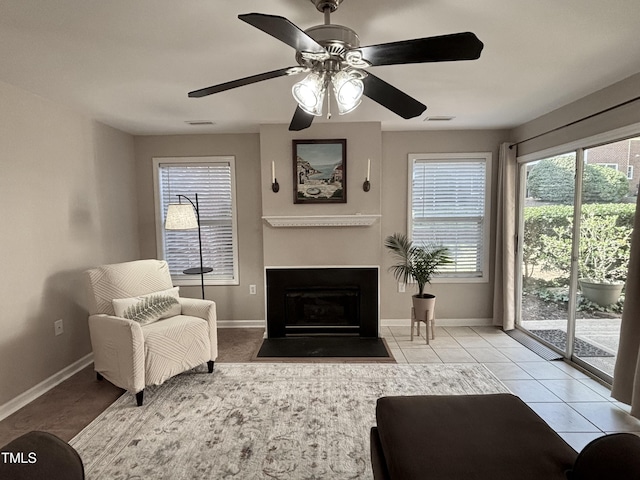 1613 Bulon Dr, Cary, NC 27518 - tiled living area with plenty of natural light, baseboards, a fireplace with flush hearth, and ceiling fan