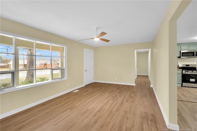 1772 Inverness Dr, Fayetteville, NC 28304 - unfurnished living room with visible vents, a ceiling fan, baseboards, and light wood-type flooring