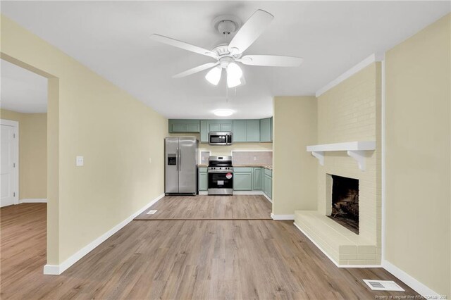 1772 Inverness Dr, Fayetteville, NC 28304 - kitchen featuring a ceiling fan, baseboards, green cabinetry, light wood-style flooring, and appliances with stainless steel finishes